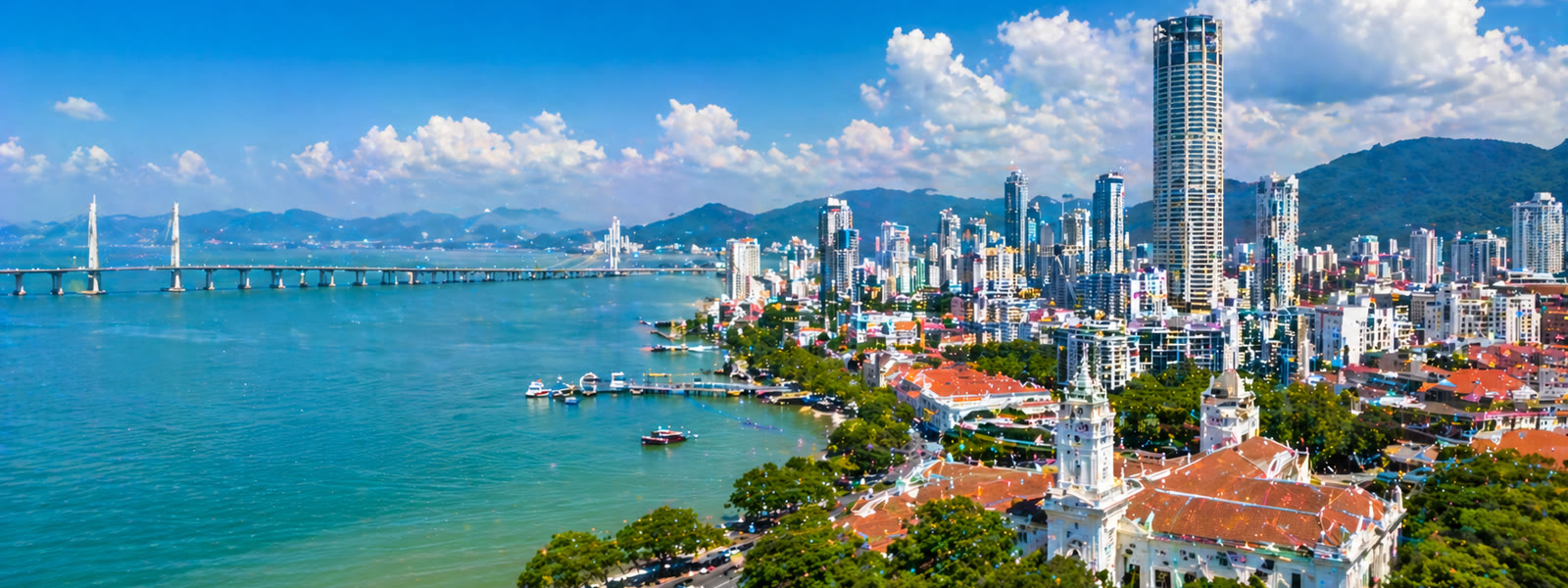 Penang skyline along the strait with George Town and Penang Bridge